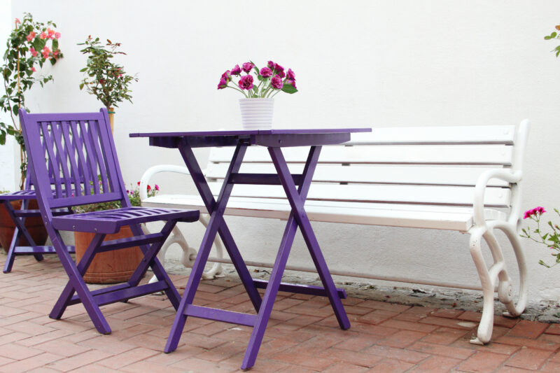 Violet,Wooden,Chairs,And,A,Table,With,A,Bouquet,Of