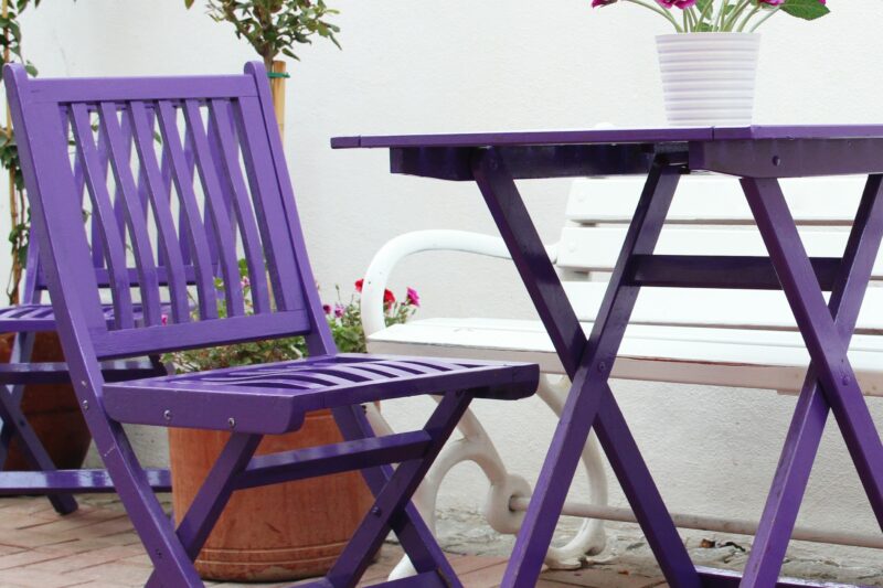 Violet,Wooden,Chairs,And,A,Table,With,A,Bouquet,Of